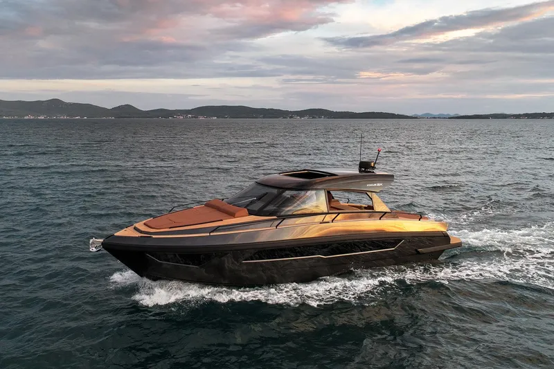 Slide: The Image of Luxurious 2025 Focus 3X yacht cruising on open water at sunset. - 1