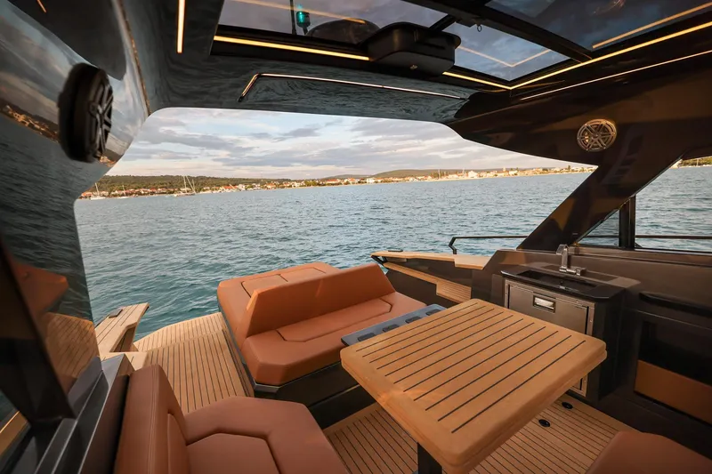 Slide: The Image of Luxurious 2025 Focus 3X yacht interior with elegant seating and scenic ocean view. - 15