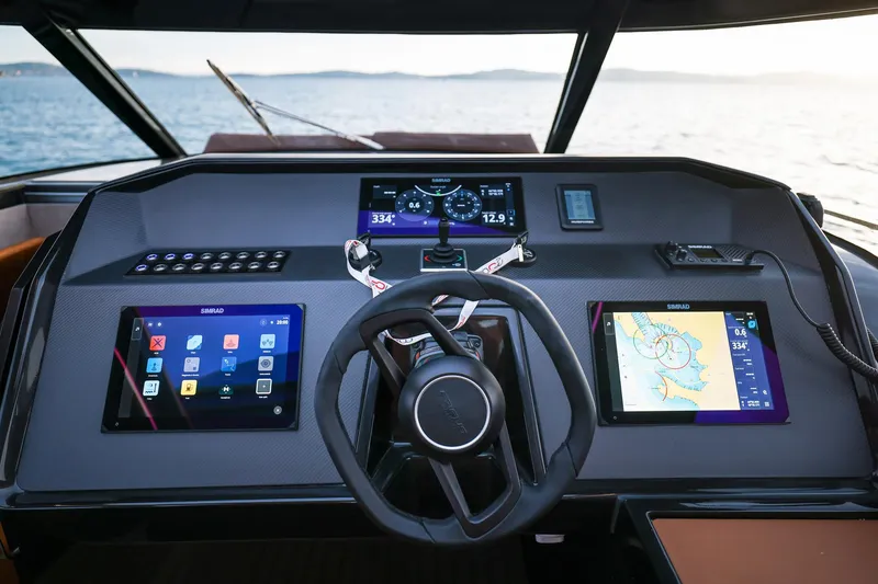 Slide: The Image of Helm of 2025 Focus 3X boat with advanced navigation displays and controls. - 27