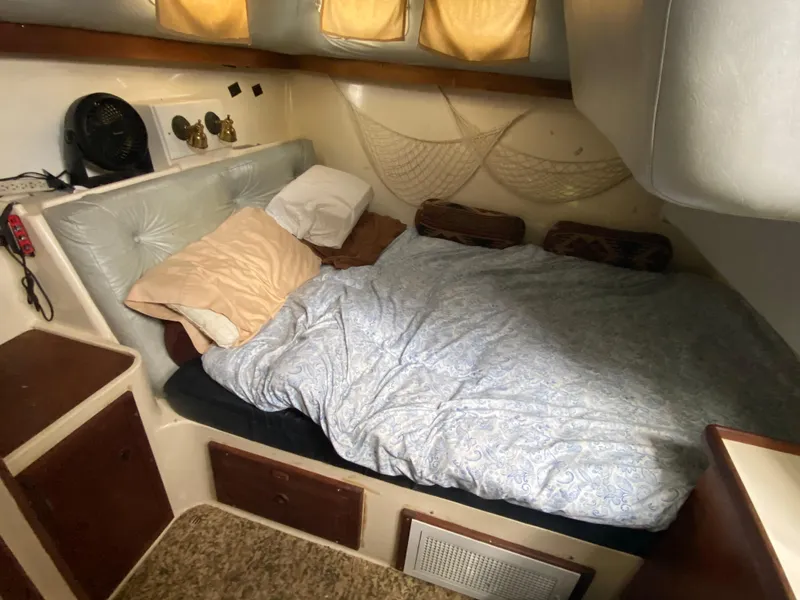 Slide: The Image of 1986 Albin 34 Family Cruiser cabin with bed, pillows, and cozy interior. - 14