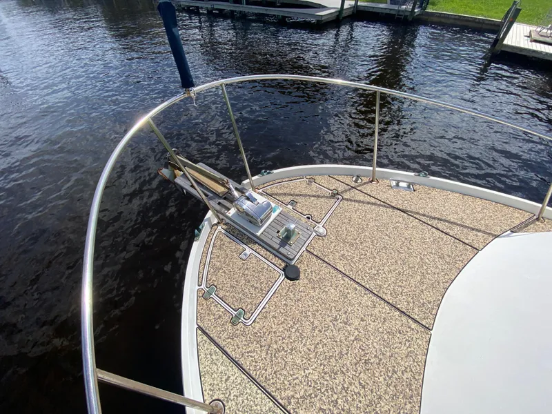Slide: The Image of 1986 Albin 34 Family Cruiser bow with anchor, docked on calm water. - 6