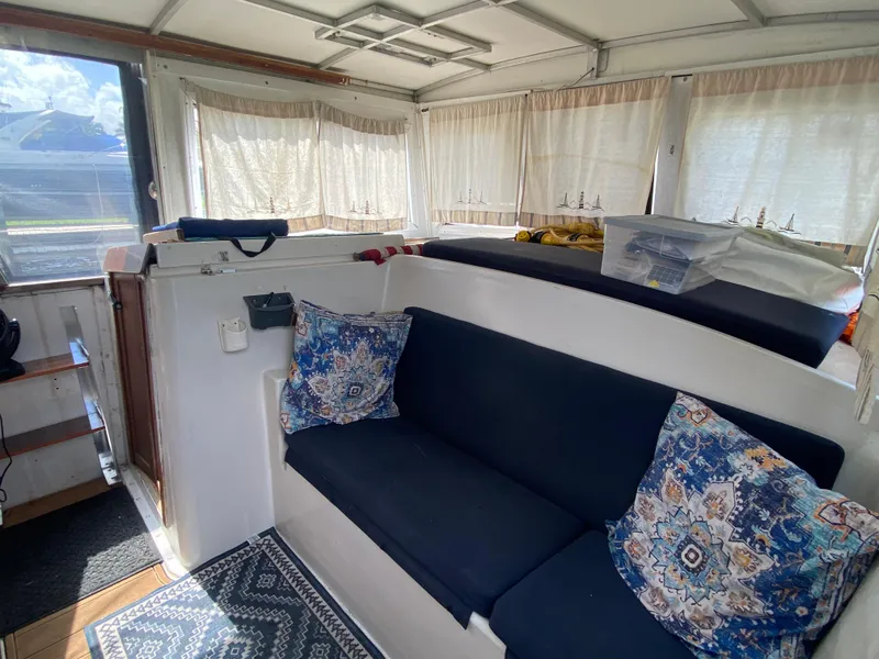Slide: The Image of Interior of 1986 Albin 34 Family Cruiser with blue seating and patterned cushions. - 8