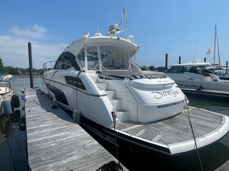 Slide: The Image of 2015 Sunseeker San Remo 48 yacht docked at marina under clear blue sky. - 11