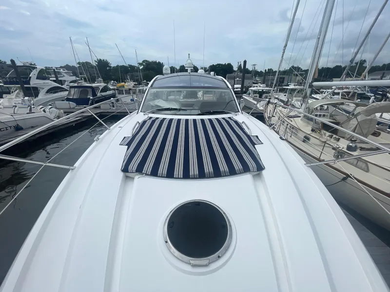 Slide: The Image of 2015 Sunseeker San Remo 48 yacht docked, featuring striped sun pad and sleek design. - 13