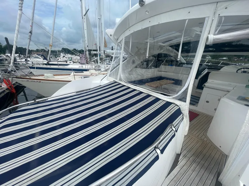 Slide: The Image of 2015 Sunseeker San Remo 48 yacht with striped deck cover at marina. - 15