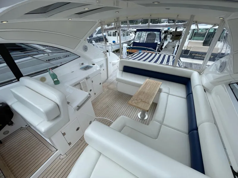 Slide: The Image of Luxurious interior of 2015 Sunseeker San Remo 48 yacht with white seating and wooden table. - 19