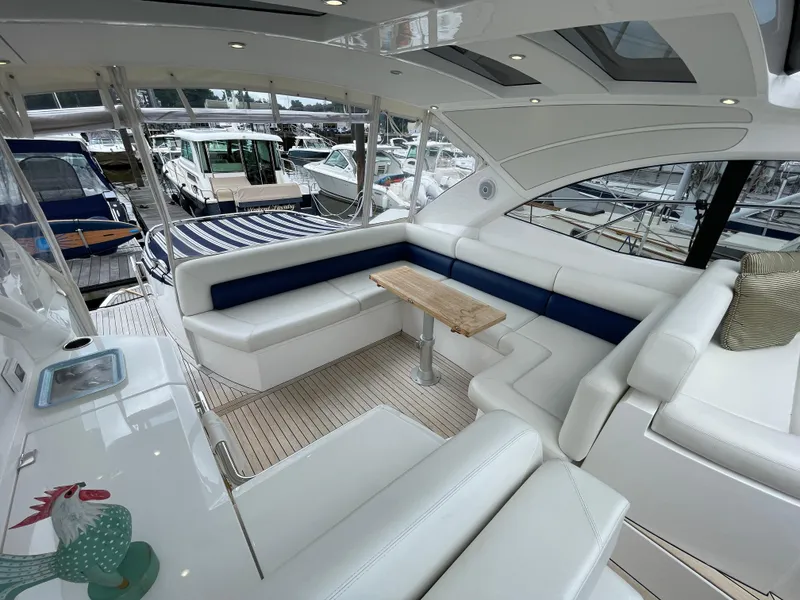 Slide: The Image of Luxurious interior of 2015 Sunseeker San Remo 48 yacht with white seating and wooden table. - 20