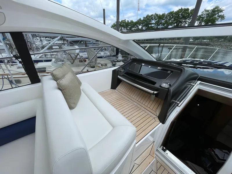 Slide: The Image of Luxurious interior of 2015 Sunseeker San Remo 48 yacht with white seating and wooden flooring. - 24