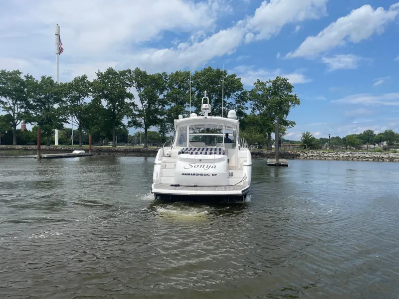 Slide: The Image of 2015 Sunseeker San Remo 48 yacht on water, trees and flag in background. - 8