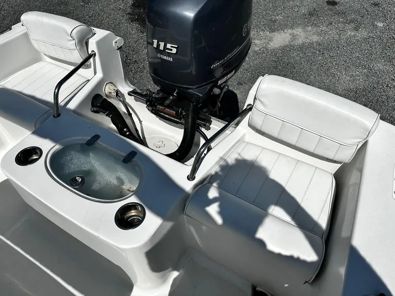 Slide: The Image of 2013 Sea Hunt Triton 202 Center Console with Yamaha 115 engine, white seating, and livewell. - 11