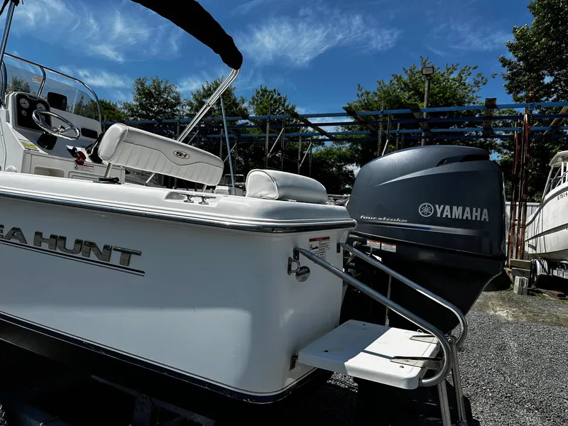 Slide: The Image of 2013 Sea Hunt Triton 202 Center Console boat with Yamaha engine, parked outdoors. - 3