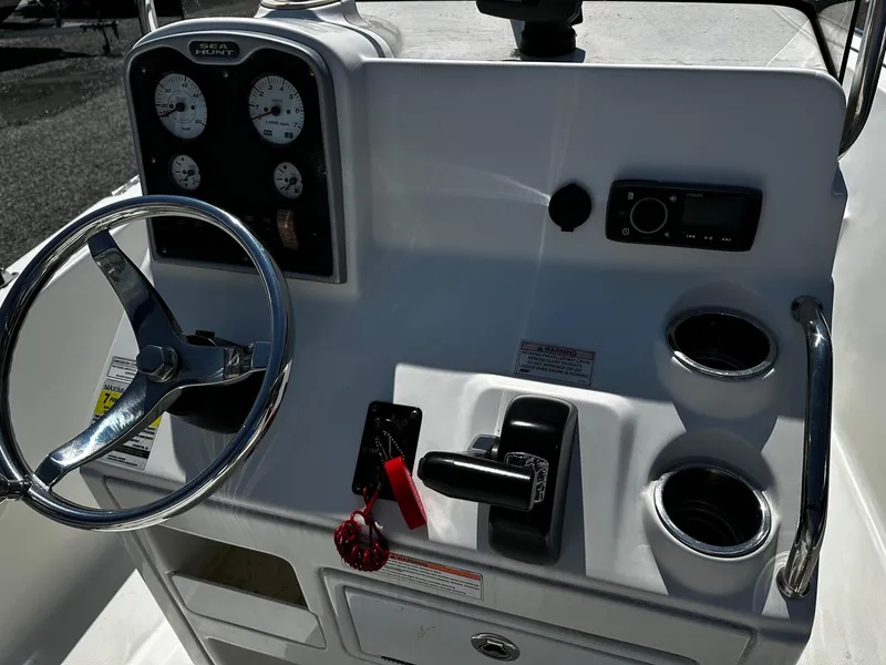Slide: The Image of 2013 Sea Hunt Triton 202 Center Console dashboard with steering wheel and controls. - 4