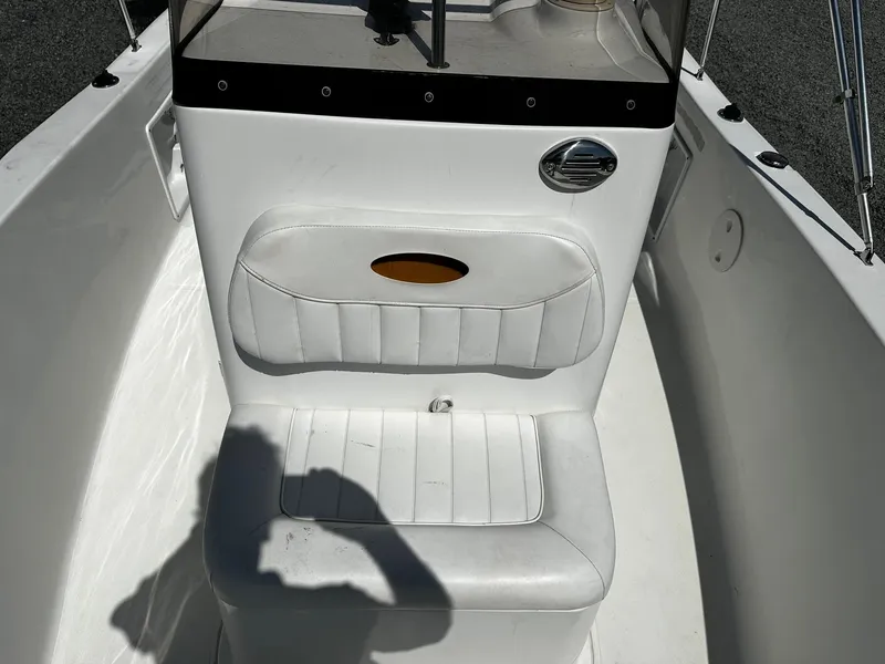 Slide: The Image of 2013 Sea Hunt Triton 202 Center Console boat seat with white upholstery and console details. - 7
