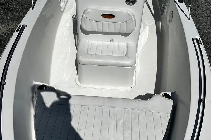 Slide: The Image of 2013 Sea Hunt Triton 202 Center Console boat interior with white seating and flooring. - 8