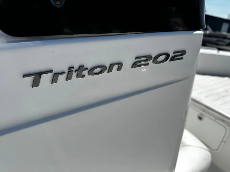 Slide: The Image of 2013 Sea Hunt Triton 202 Center Console boat, close-up of model name. - 9