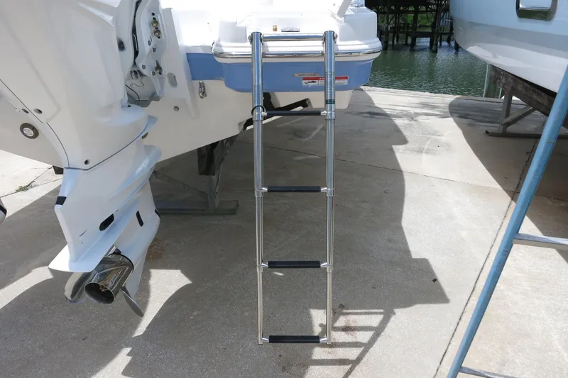 Slide: The Image of 2025 Robalo R317 Dual Console boat with extended swim ladder. - 11