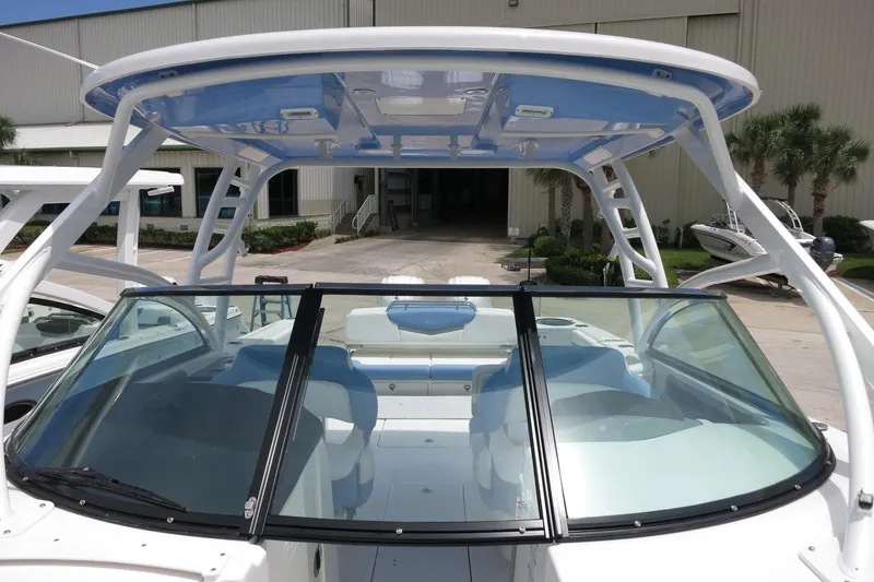 Slide: The Image of 2025 Robalo R317 Dual Console boat with sleek design and spacious seating. - 24