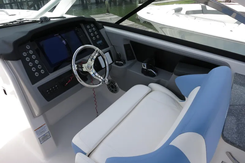 Slide: The Image of 2025 Robalo R317 Dual Console boat cockpit with modern steering and controls. - 27