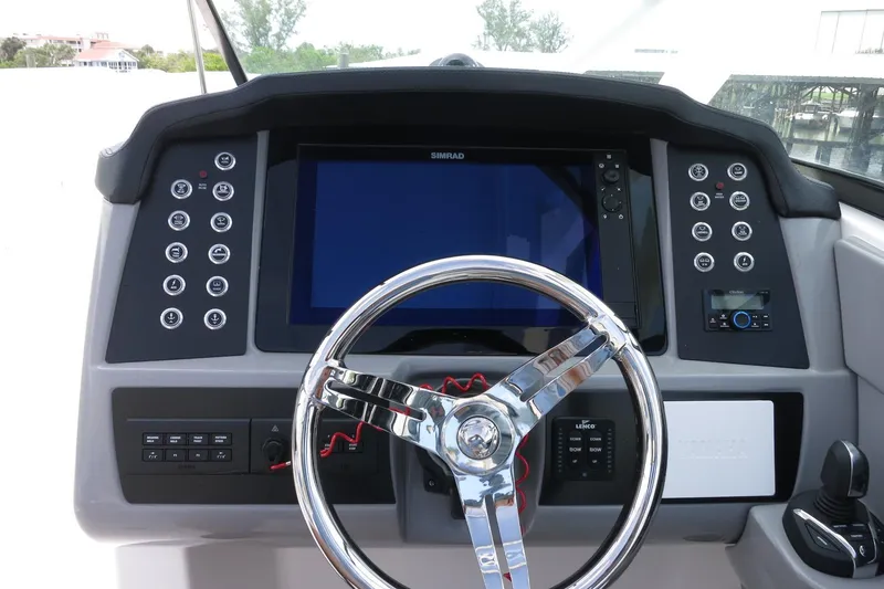 Slide: The Image of 2025 Robalo R317 Dual Console dashboard with steering wheel and control panel. - 28