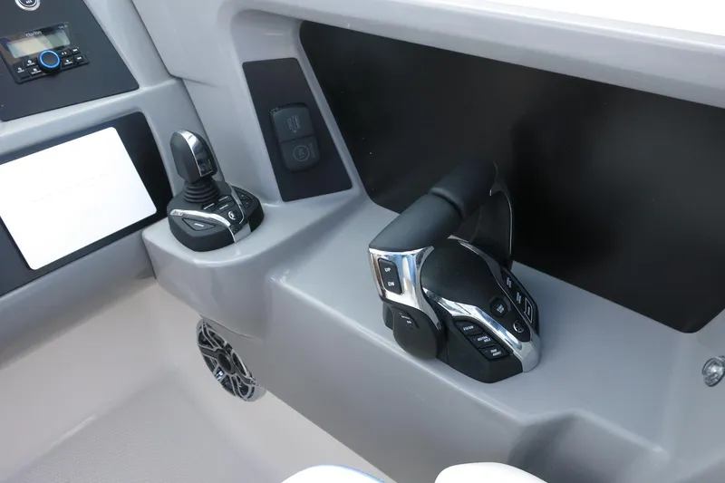 Slide: The Image of 2025 Robalo R317 Dual Console boat controls with joystick and throttle. - 29