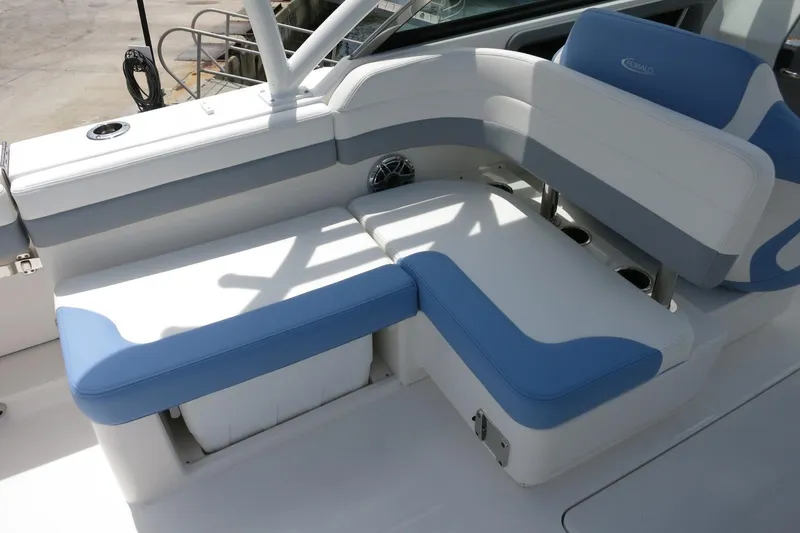 Slide: The Image of 2025 Robalo R317 Dual Console boat seating with blue and white cushions. - 33