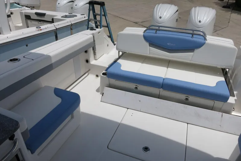 Slide: The Image of 2025 Robalo R317 Dual Console boat interior with blue and white seating. - 34