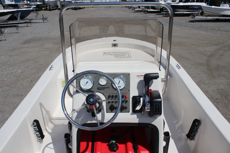 Slide: The Image of 2025 Carolina Skiff E18 JVX CC boat console with steering wheel and controls. - 11