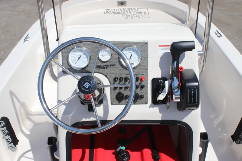 Slide: The Image of 2025 Carolina Skiff E18 JVX CC boat console with steering wheel and controls. - 12