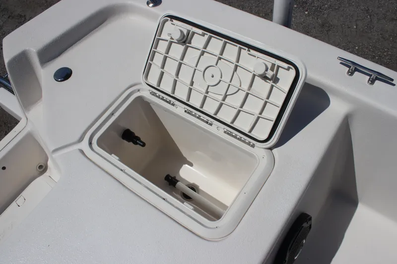 Slide: The Image of 2025 Carolina Skiff E18 JVX CC boat storage compartment with open lid. - 14