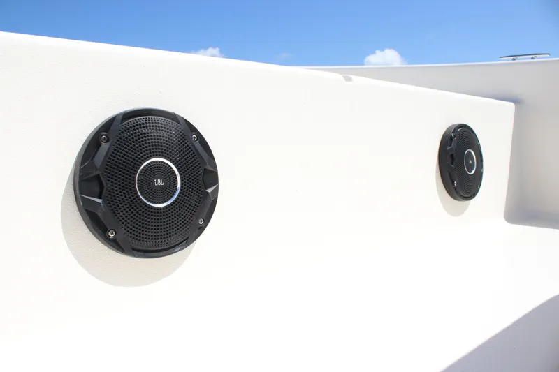 Slide: The Image of Speakers on 2025 Carolina Skiff E18 JVX CC boat, under clear blue sky. - 16