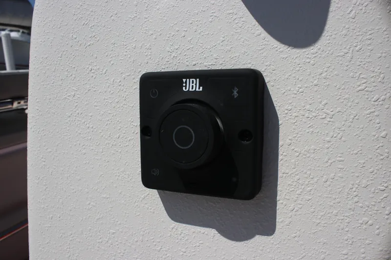 Slide: The Image of JBL audio control panel on 2025 Carolina Skiff E18 JVX CC boat. - 18