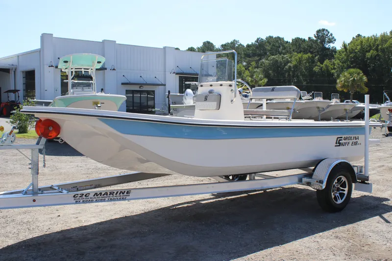 Slide: The Image of 2025 Carolina Skiff E18 JVX CC boat on trailer at dealership. - 3