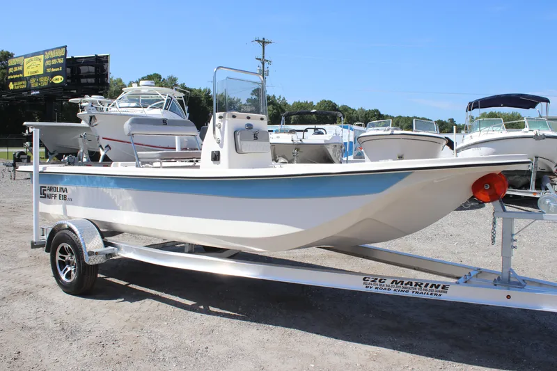 Slide: The Image of 2025 Carolina Skiff E18 JVX CC boat on trailer in outdoor showroom. - 4