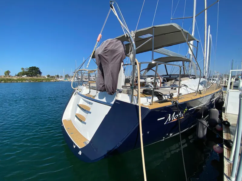 Slide: The Image of 2013 Jeanneau 57 yacht docked in marina under clear blue sky. - 11