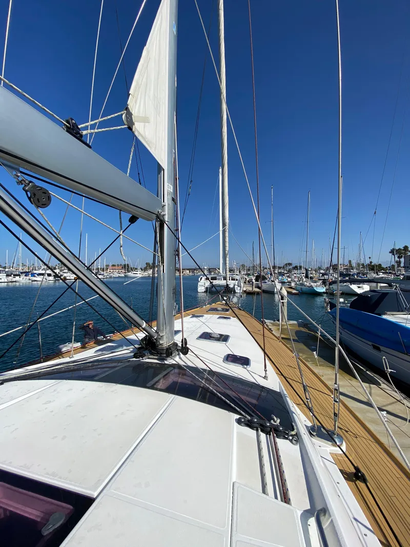 Slide: The Image of 2013 Jeanneau 57 sailboat docked in a sunny marina. - 17