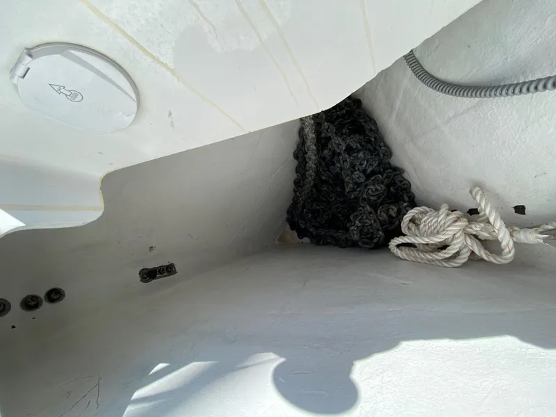 Slide: The Image of Interior view of 2013 Jeanneau 57 sailboat with ropes and storage area. - 23