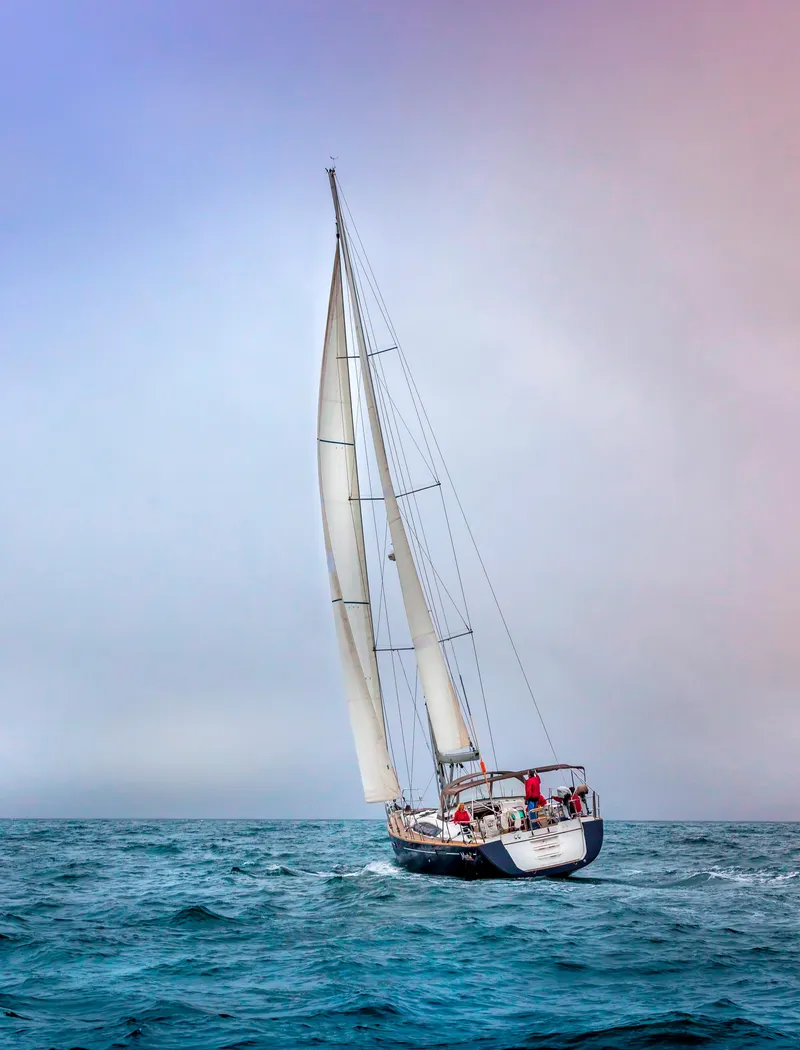 Slide: The Image of Sailing yacht Jeanneau 57, 2013 model, navigating open sea under vibrant sky. - 3