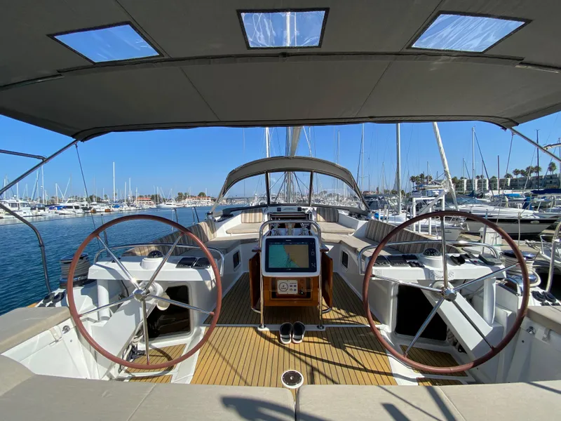 Slide: The Image of 2013 Jeanneau 57 yacht cockpit with dual steering wheels in marina. - 34