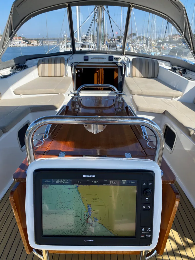Slide: The Image of 2013 Jeanneau 57 yacht cockpit with navigation system and seating area. - 47