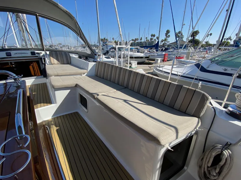 Slide: The Image of Jeanneau 57 yacht deck, 2013 model, with comfortable seating in a marina. - 48