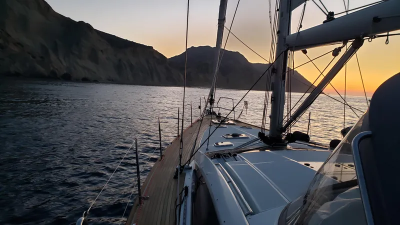 Slide: The Image of Jeanneau 57 sailing at sunset near rocky coastline, 2013 model. - 7