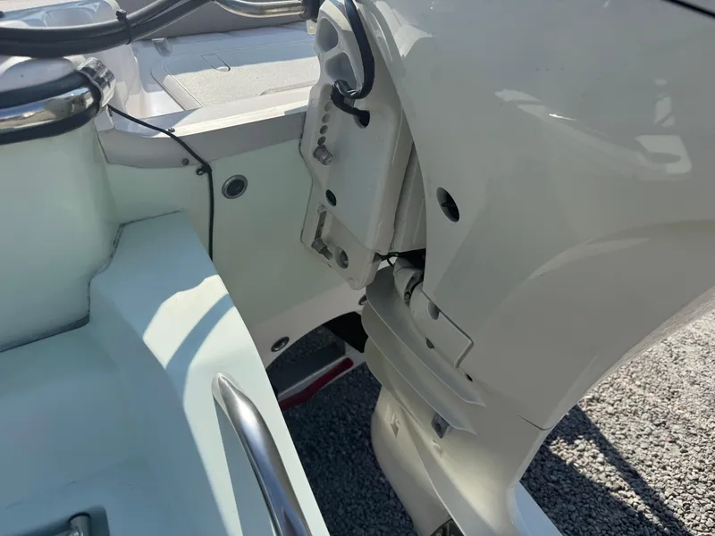 Slide: The Image of Close-up of a 2020 Sundance 20DX boat's motor and interior details. - 4