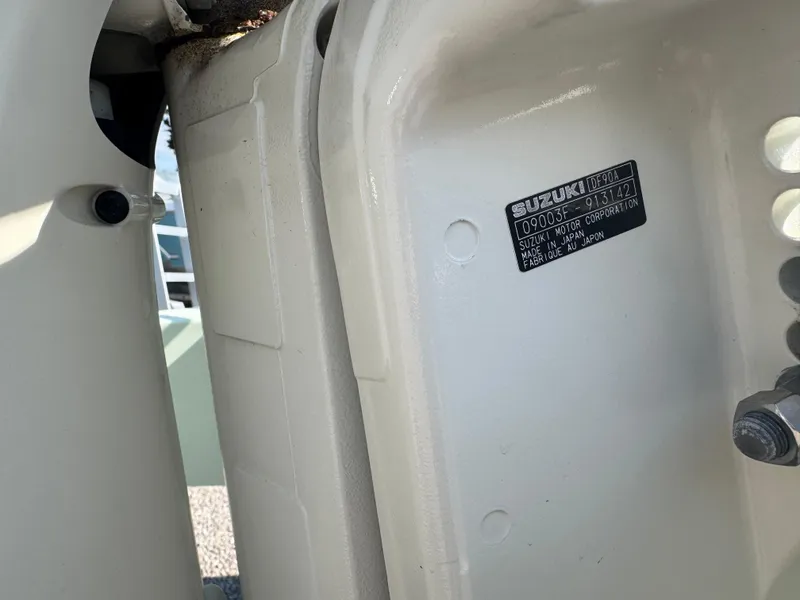 Slide: The Image of Close-up of a 2020 Sundance 20DX boat with Suzuki motor label. - 5