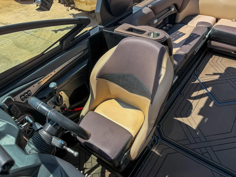 Slide: The Image of 2018 Supra SE 450 boat interior with steering wheel and seating. - 10