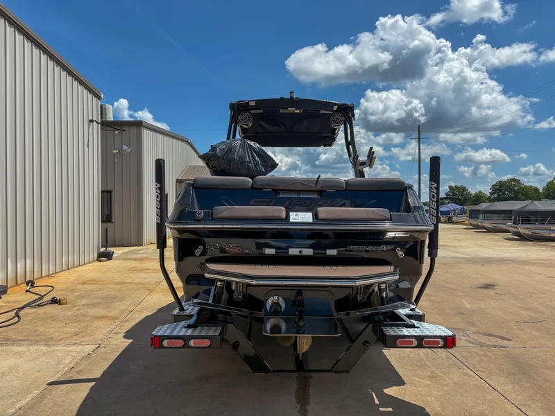 Slide: The Image of 2018 Supra SE 450 boat parked outdoors under a clear blue sky. - 3