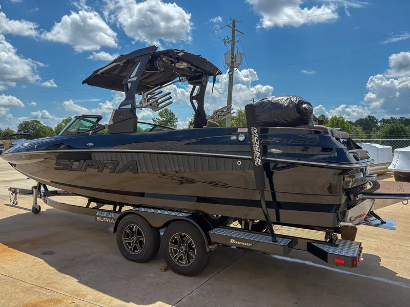 Slide: The Image of 2018 Supra SE 450 boat on trailer under blue sky with clouds. - 4