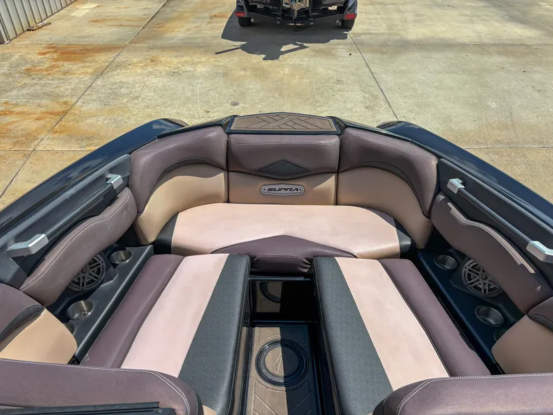 Slide: The Image of 2018 Supra SE 450 boat interior with cushioned seating and cup holders. - 7