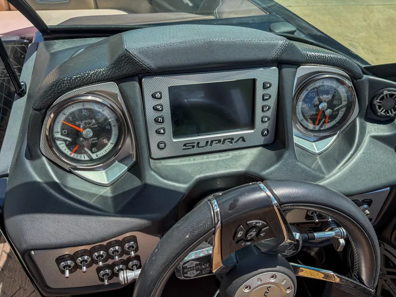 Slide: The Image of Dashboard of a 2018 Supra SE 450 boat with gauges and controls. - 9