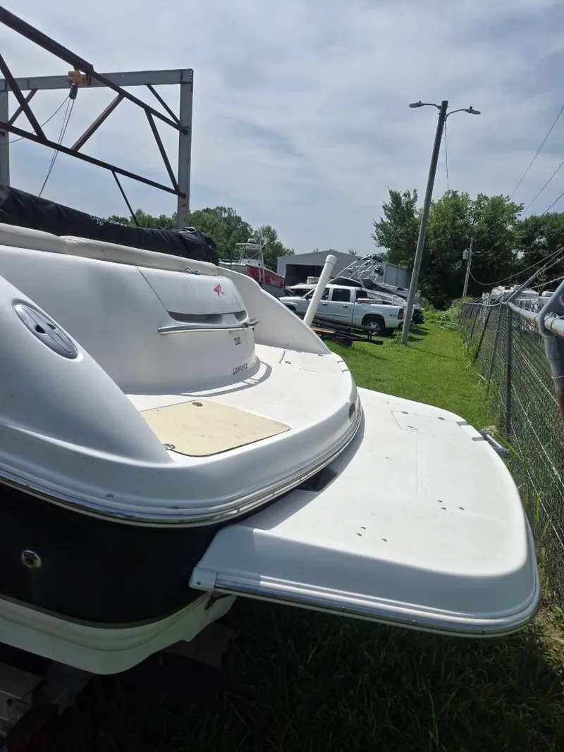 Slide: The Image of 2001 Chaparral 230 SSi boat rear view with swim platform, parked outdoors. - 2