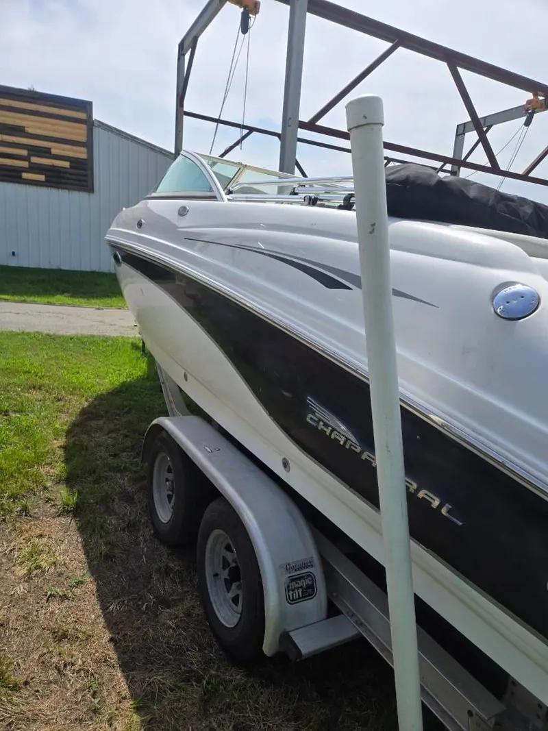 Slide: The Image of 2001 Chaparral 230 SSi boat on trailer, parked outdoors near a building. - 3